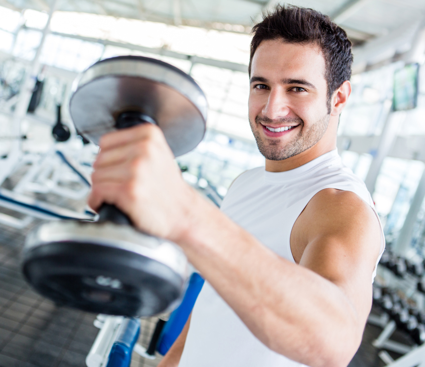 Strong man at the gym lifting weights